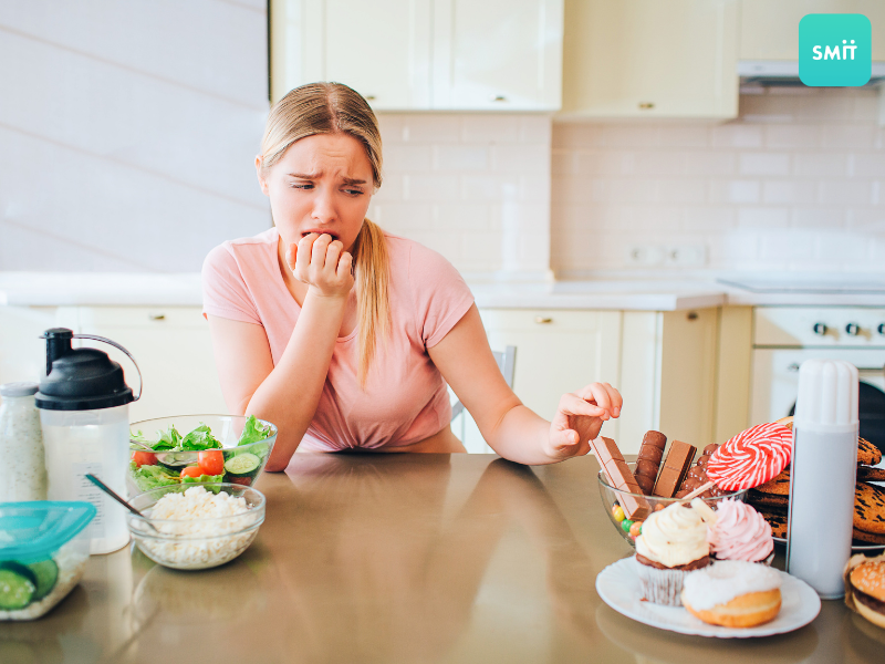 woman choosing between sugar and veggies